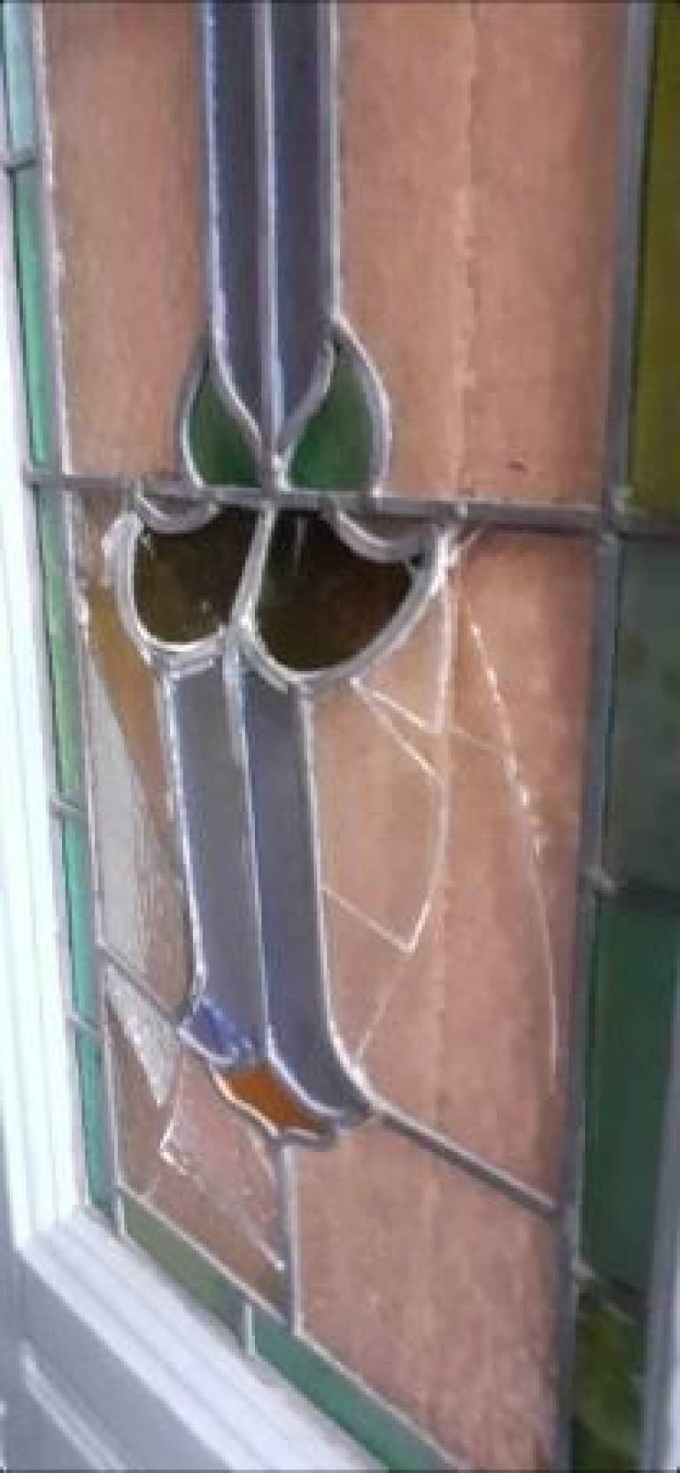 A broken front door window  - Caroline Channing